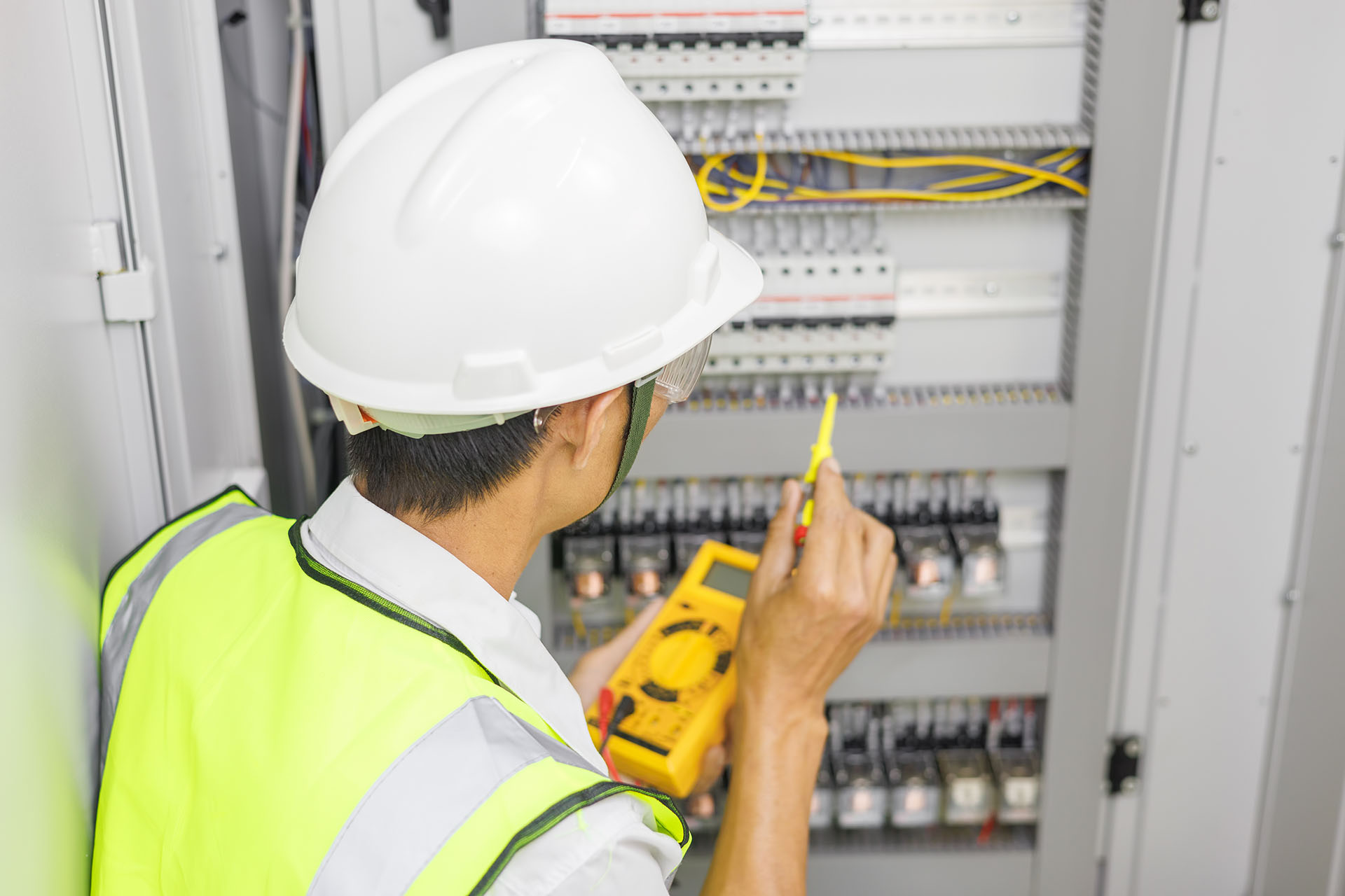 Electrical Engineer Or Repairman Holding Digital Multimeter To I